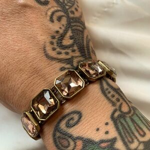 Peach colored crystals set in patina gold.